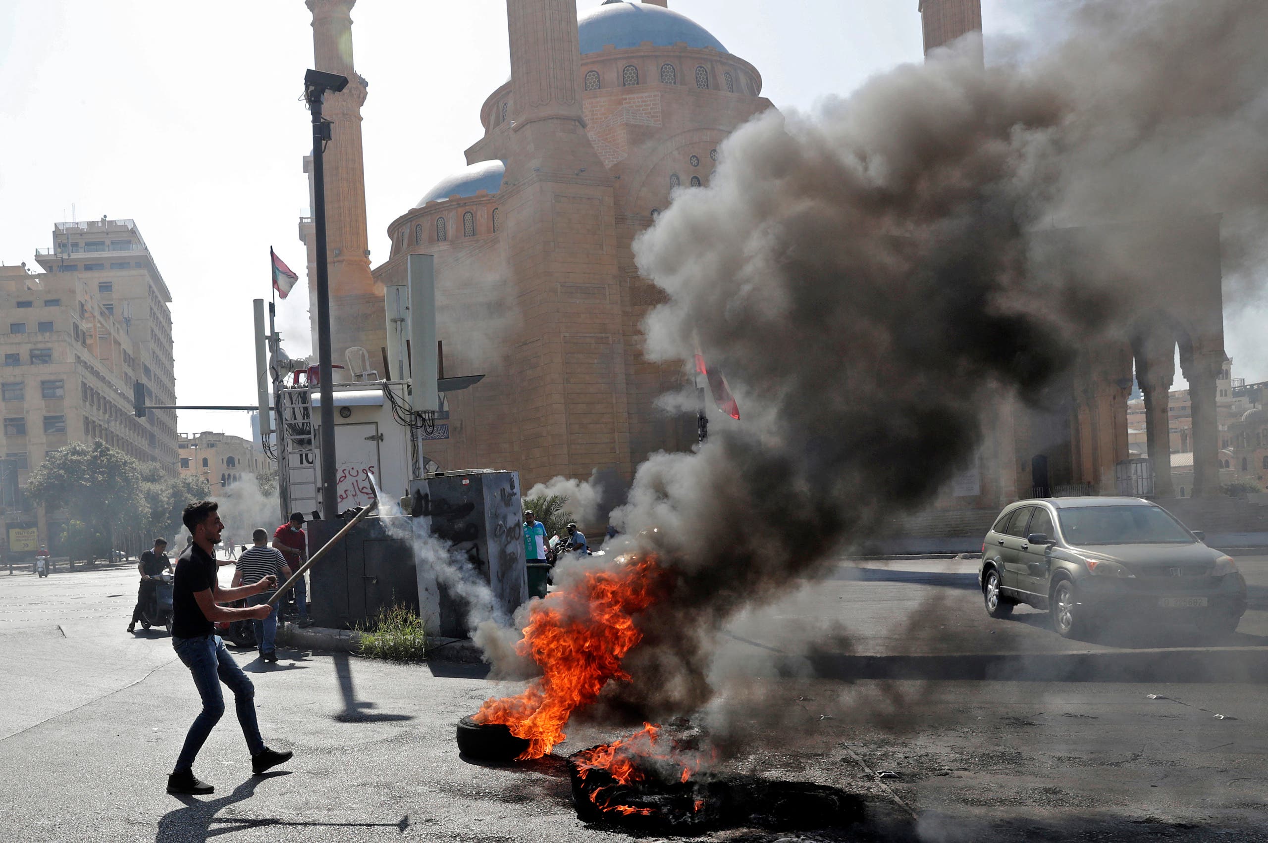 Demonstrators burn tires to block the Martyrs' Square in the centre of Lebanon's capital Beirut on June 26, 2021, as they protest against dire living conditions amidst the ongoing economical and political crisis. (AFP)
