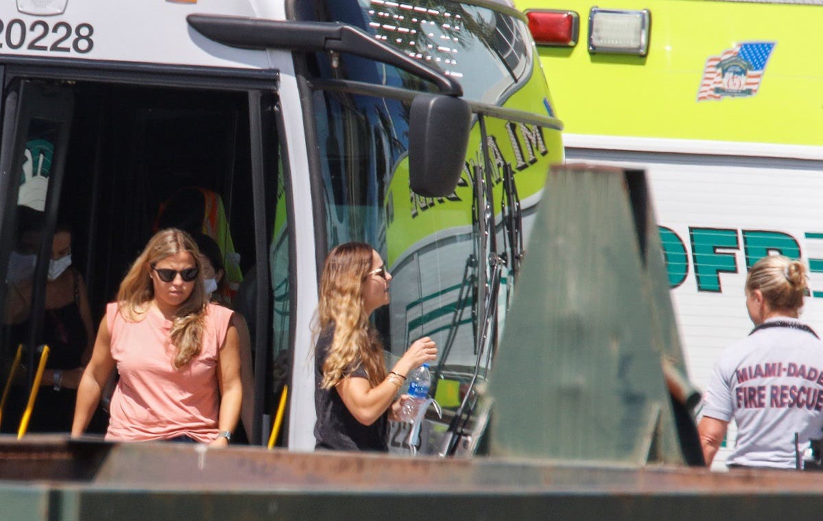 Family members of those reported missing depart a bus to view the site of a partially collapsed residential building in Surfside, near Miami Beach, Florida, U.S. June 27, 2021. (Reuters)