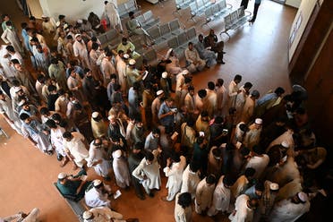 People including overseas Pakistani workers who want to fly to the Middle East stand in a queue to register before receiving a dose of the Pfizer Covid-19 vaccine at a vaccination center in Islamabad on June 28, 2021. (AFP)