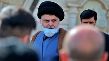 Muqtada al-Sadr, center, leaves a news conference in Najaf, Iraq, Wednesday, Feb. 10, 2021. (AP)