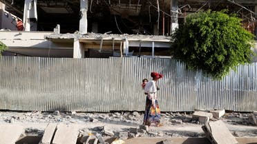 A woman walks past the rubble of a building damaged by fighting in the town of Shire, Tigray region, Ethiopia, March 17, 2021.(Reuters)