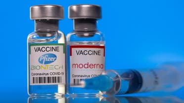 Vials with Pfizer-BioNTech and Moderna coronavirus disease vaccine labels are seen in this illustration picture taken March 19, 2021. (Reuters/Dado Ruvic)