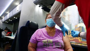 LOS ANGELES, CALIFORNIA - JUNE 25: A person receives a COVID-19 vaccination dose at a Walgreens mobile bus clinic on June 25, 2021 in Los Angeles, California. The United States will miss President Joe Biden's goal of delivering at least one coronavirus vaccine dose to 70 percent of adults by the July 4th holiday. Mario Tama/Getty Images/AFP