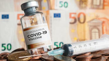 Vial of coronavirus Covid-19 vaccine and an hypodermic syringe sorrounded by euro coins and banknotes stock photo