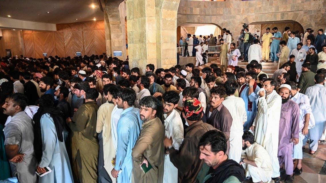 People including overseas Pakistani workers who want to fly to the Middle East stand in a queue to register before receiving a dose of the Pfizer Covid-19 vaccine at a vaccination center in Islamabad on June 28, 2021. (AFP)