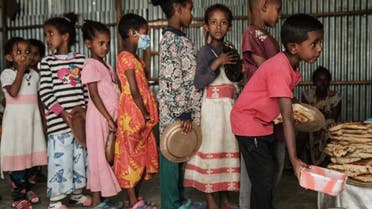 Children, who fled the violence in Ethiopia's, Tigray region, wait in line for breakfast organized by a self-volunteer Mahlet Tadesse, 27, in Mekele, the capital of Tigray region, on June 23, 2021. Mahlet Tadesse, a former business woman now studying masters in sociology at Mekelle University, supports about 100 women with 155 kids at Midregenet Elderly Center. She negotiated with the city to transform the public building into an IDP camp to host pregnant or lactating mothers from other IDP camps in inferior conditions two months ago.