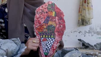 Gaza artist paints on the remains of her demolished house