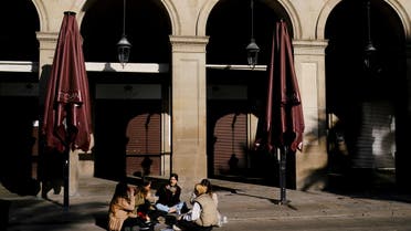 Women eat while sitting in front of a closed restaurant at the empty Plaza Reial (Reial square), after Catalonia's government imposed new restrictions in an effort to control the spread of the coronavirus disease (COVID-19), in Barcelona, Spain January 26, 2021. REUTERS/Nacho Doce