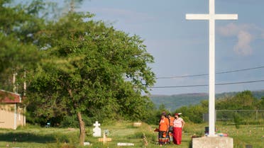 A group of women walk in a field where human remains were discovered in unmarked graves at the site of the former Marieval Indian Residential School on the Cowessess First Nation in Saskatchewan on June 26, 2021. More than 750 unmarked graves have been found near a former Catholic boarding school for indigenous children in western Canada, a tribal leader said. (File photo: AFP)