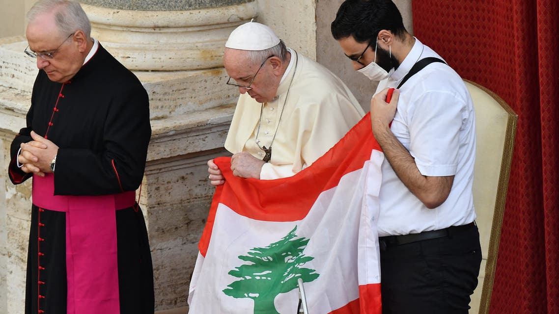 (From L)Monsignor Leonardo Sapienza, Pope Francis and a Lebanese priest holding Lebanon's flag pray for Lebanon during the Pope's limited public audience at the San Damaso courtyard in The Vatican on September 2, 2020. (AFP)