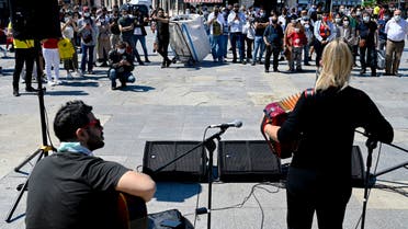 Musician Ozge Metin (back,R) sings to a dancing crowd in Istanbul on June 9, 2021 as the Istanbul Municipality has launched the Istanbul is a Stage project, allowing musicians to sing and dance on open squares. Bars and restaurants have reopened as Turkey pulls out of the Covid-19 pandemic's third wave, but the musicians feel unfairly singled out.