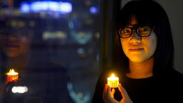 Vice-chairwoman of Hong Kong Alliance in Support of Patriotic Democratic Movements of China, Chow Hang-tung, poses with a candle ahead of the 32nd anniversary of the crackdown on pro-democracy demonstrators at Beijing’s Tiananmen Square in 1989, in Hong Kong, China, on June 3, 2021. (Reuters)