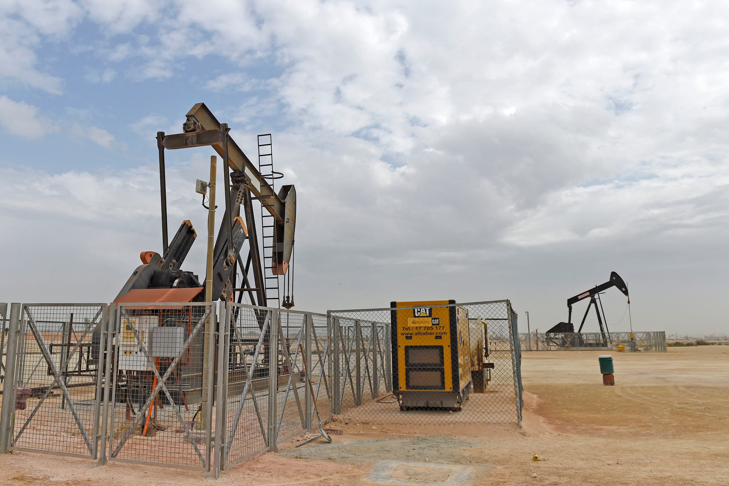 Pumpjacks operate in the desert oil fields of Sakhir in southern Bahrain on April 22, 2020. (AFP)