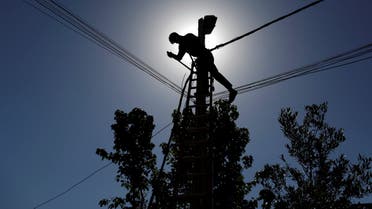 An Iraqi technician works on an electricity pole damaged during fighting between Iraqi forces and ISIS militans, in eastern Mosul. (File Photo: Iraq)