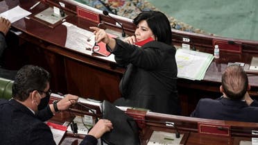 Abir Moussi (C), president of the Free Destourian Party (PLD), lifts her face mask as she gestures during a parliamentary session as Tunisian lawmakers debate ahead of a confidence vote on the new government reshuffle by the prime minister at the Tunisian Assembly headquarters in the capital Tunis on January 26, 2021. (AFP)