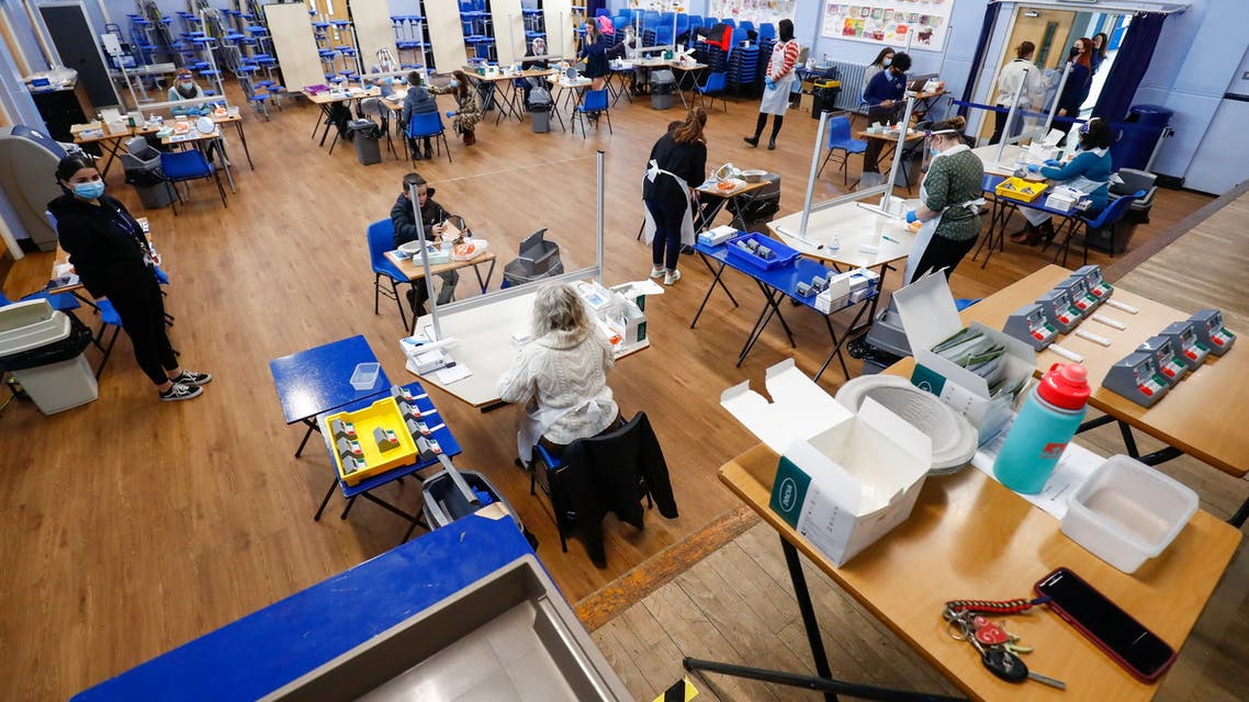 Students take lateral flow tests as health workers supervise at Weaverham High School, as the coronavirus disease (COVID-19) lockdown begins to ease, in Cheshire, Britain, March 9, 2021. (Reuters)