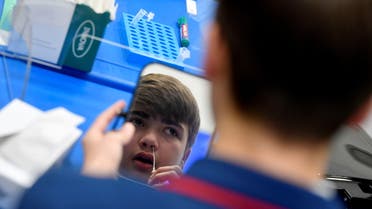 Year 10 student, Isaac O'Hare, 15, takes a coronavirus disease (COVID-19) test at Harris Academy Beckenham , ahead of full school reopening in England as part of lockdown restrictions being eased, in Beckenham, south east London, Britain, March 5, 2021. (Reuters)