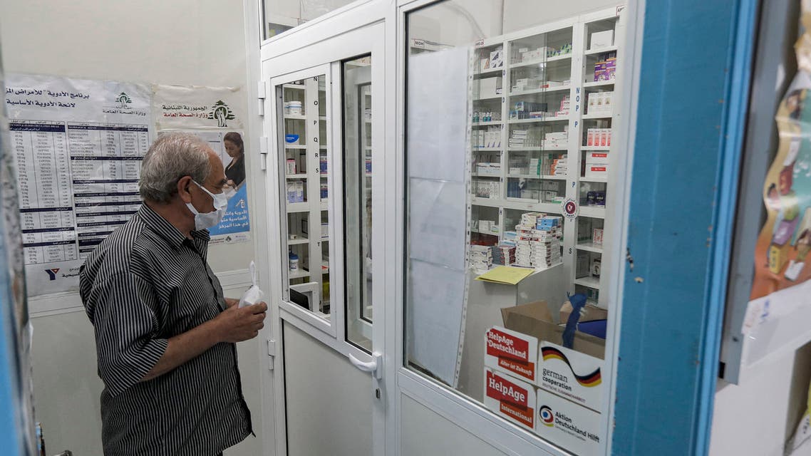 A man, mask-clad due to the COVID-19 coronavirus pandemic, waits to receive medication from the pharmacy of the Amel NGO in Lebanon's southern coastal city of Tyre on July 22, 2020. (File photo: AFP)