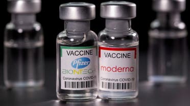 Vials with Pfizer-BioNTech and Moderna coronavirus disease (COVID-19) vaccine labels are seen, March 19, 2021. (Reuters)