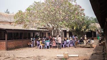 A group of HIV-positive children wait under a tree to receive their antiretroviral drugs at the Bangui pediatric complex, Central African Republic, December 4, 2018. (Florent Vergnes/AFP)