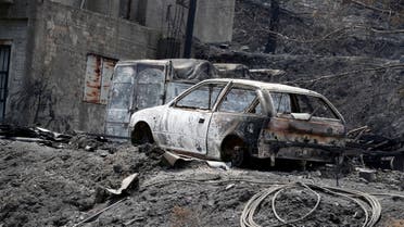 Burned house and cars are seen following a wildfire near the village of Melini, in the Larnaca mountain region, Cyprus July 4, 2021. (Reuters)