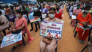 A Christian nun, center, and others hold placards demanding the release of tribal rights activist Stan Swamy as they listen to a speaker during a demonstration in Bengaluru, India, Nov.12, 2020. (AP/Aijaz Rahi)