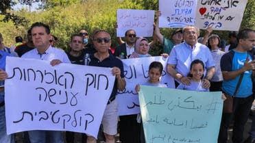 فلسطينيون وعرب إسرائيليون يتظاهرون ضد قانون المواطنة والدخول إلى إسرائيل الذي تم سنه في عام 2003 من أمام الكنيست، 29 يونيو، 2021