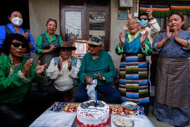 Tibetans dressed in traditional attire sing the birthday song before cutting a cake during a function organized to mark the 86th birthday celebration of Dalai Lama in Lalitpur, Nepal, on July 6, 2021. (Reuters)