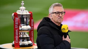 Gary Lineker performing media duties next to the FA Cup trophy before the match in March 2021. (Reuters)