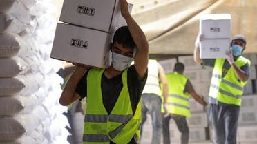 2021-07-07TWorkers carry boxes of humanitarian aid near Bab al-Hawa crossing at the Syrian-Turkish border, in Idlib governorate, Syria, on June 30, 2021. (Reuters)130126Z_733236774_RC2YAO9A69X5_RTRMADP_3_SYRIA-SECURITY-CROSSING