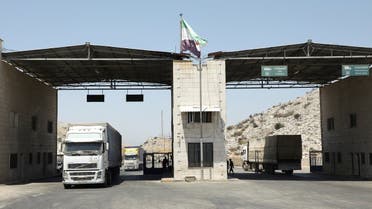 Trucks drive at Bab al-Hawa crossing at the Syrian-Turkish border, in Idlib governorate, Syria, on June 30, 2021. (Reuters)
