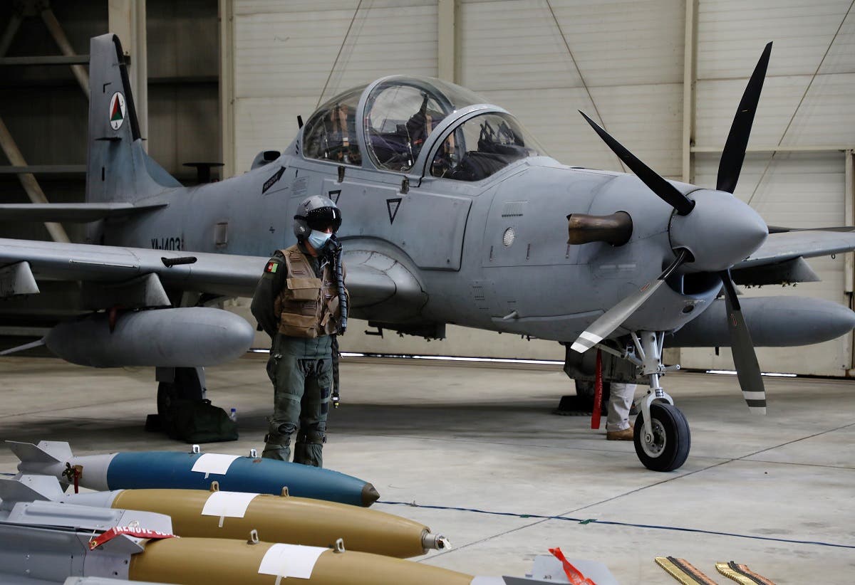 An Afghan pilot stands next to A-29 Super Tucano plane during a handover ceremony of A-29 Super Tucano planes from US to the Afghan forces, in Kabul, Afghanistan, on September 17, 2020. (Reuters)