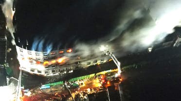 An aerial photo show firefighters trying to extinguish a massive fire that broke out in a beverage and food factory in Narayanganj, central Bangladesh on July 9, 2021. (File photo: AFP)