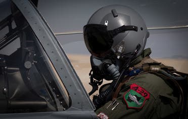 An Afghan A-29 pilot prepared for flight in the cockpit of his aircraft, at Kandahar Airfield, Afghanistan. (Reuters)