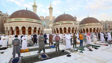 Muslim worshippers perform the Eid al-Fitr morning prayer at the Grand Mosque in Saudi Arabia's holy city of Mecca to mark the end of the fasting month of Ramadan, on May 13, 2021. (AFP)