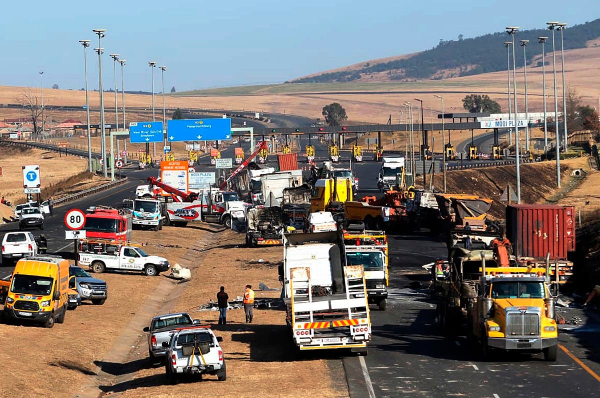 A section of a main freeway, at the Mooi River Plaza in the KwaZulu-Natal Province, South Africa, is blocked off, Saturday, July 10, 2021 after trucks were set alight in overnight protests by supporters of former South African president Jacob Zuma who was imprisoned this week for contempt of court. (AP)