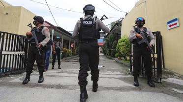 Police officers stand guard at a local police hospital where the bodies of militants killed during a raid were taken to, in Palu, Central Sulawesi, Indonesia, Sunday, July 11, 2021. Indonesian security forces say they have killed two suspected militants with ties to the Islamic State group and who are believed to be connected to the killing of Christian farmers. (AP)