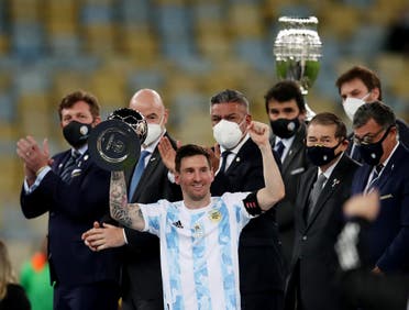 Argentina's Lionel Messi celebrates winning the Copa America with the trophy. (Reuters)