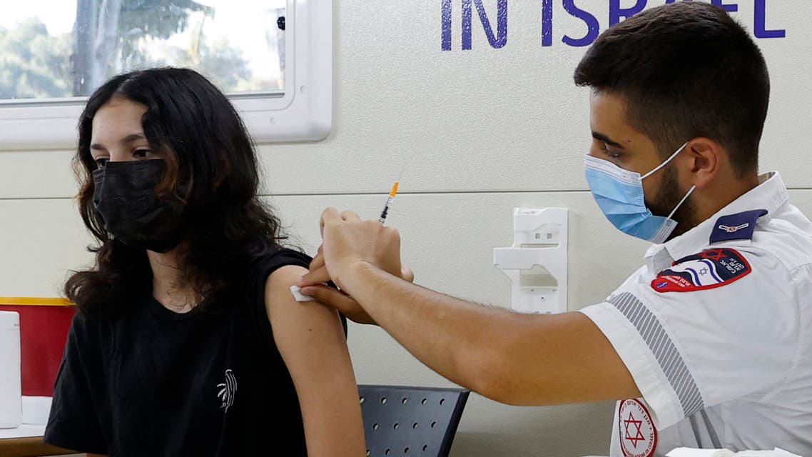 An Israeli girl receives a dose of the Pfizer/BioNTech Covid-19 vaccine from the Magen David Adom during a campaign by the Tel Aviv-Yafo Municipality to encourage the vaccination of teenagers, on July 5, 2021, in Tel Aviv. Israel is now urging more 12- to 15-year-olds to be vaccinated, citing new outbreaks attributed to the more infectious Delta variant.