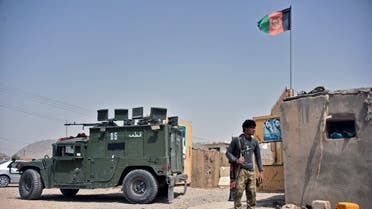 An Afghan security personnel stands guard at the site of a car bomb attack in Kandahar on July 6, 2021.