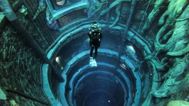 A diver experiences Deep Dive Dubai, the deepest swimming pool in the world reaching 60m, in the United Arab Emirates, on July 10, 2021. (AFP)