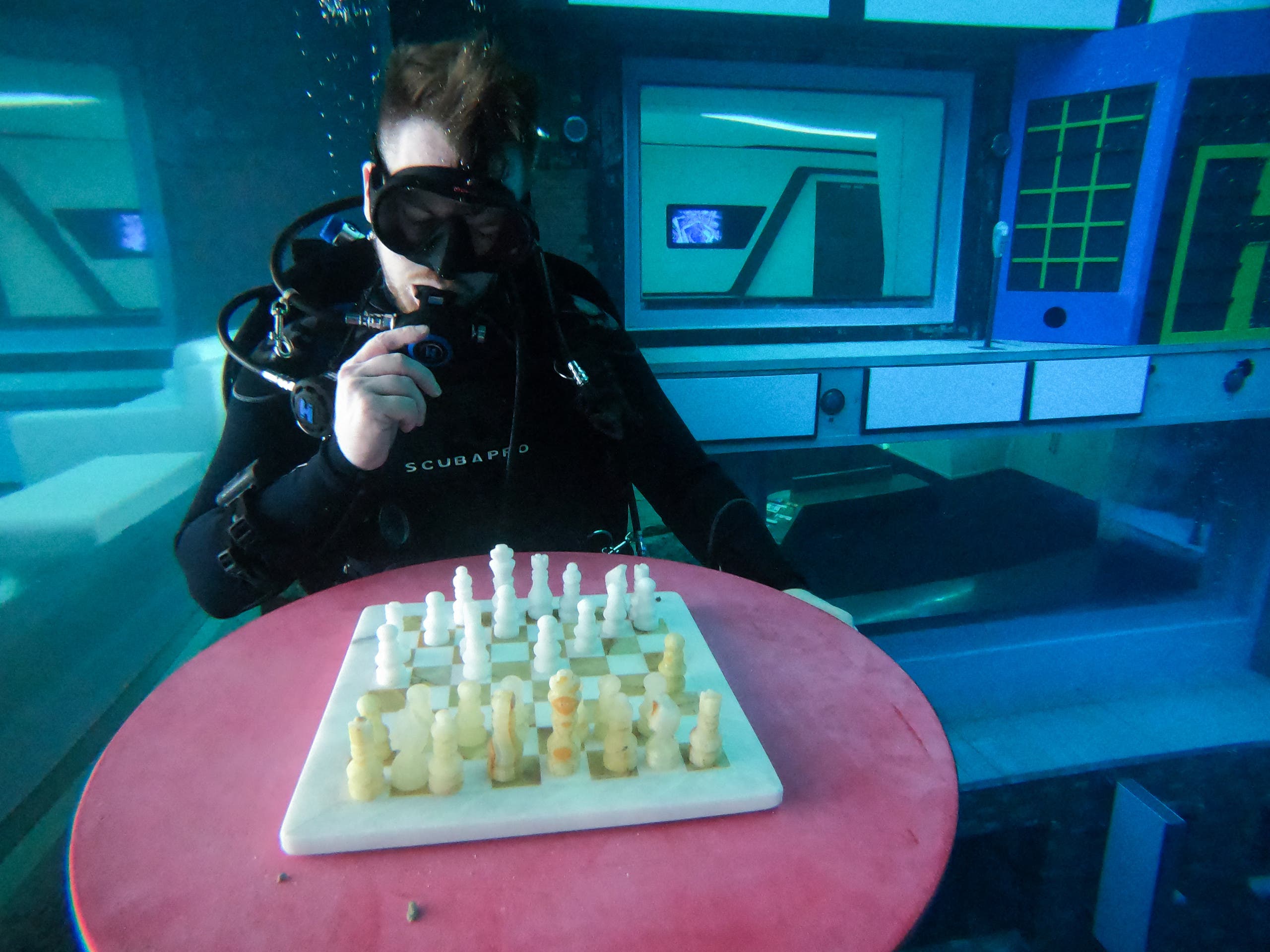 A diver plays mock chess as he experiences Deep Dive Dubai, the deepest swimming pool in the world reaching 60m, in the United Arab Emirates, on July 10, 2021. (AFP)