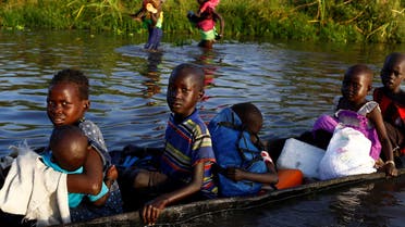 Children cross a body of water on a canoe o reach a registration area prior to a food distribution carried out by the United Nations World Food Programme (WFP) in Thonyor, Leer state, South Sudan, February 25, 2017. (Reuters)
