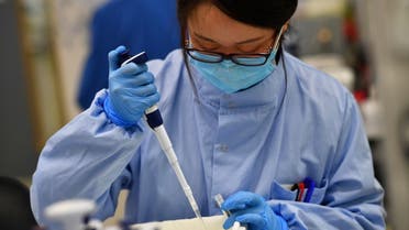 Scientists work at a laboratory where they sequence the novel coronavirus genomes at COVID-19 Genomics UK, on the Wellcome Sanger Institute's 55-acre campus south of Cambridge, Britain March 12, 2021. Picture taken March 12, 2021. REUTERS/Dylan Martinez