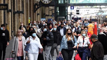 People wearing protective face masks walk along a platform at King’s Cross Station, amid the coronavirus disease (COVID-19) outbreak in London, Britain, July 12, 2021. (Reuters/Henry Nicholls)
