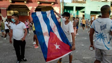 People take part in a demonstration against the government of Cuban President Miguel Diaz-Canel in Havana, on July 11, 2021. Thousands of Cubans took part in rare protests Sunday against the communist government, marching through a town chanting Down with the dictatorship and We want liberty.