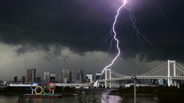 A lightening is seen over the giant Olympic rings and the Rainbow Bridge from the waterfront area of Odaiba Marine Park, ahead of the opening of the 2020 Tokyo Olympic Games, that have been postponed to 2021 due to the coronavirus disease (COVID-19) outbreak, in Tokyo, Japan July 11, 2021. (Reuters)