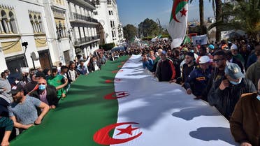 Algerian anti-government protesters take the streets of Algiers on March 26, 2021 as the Hirak pro-democracy movement keeps up its weekly demonstrations despite a ban on gatherings due to the coronavirus pandemic. (AFP)