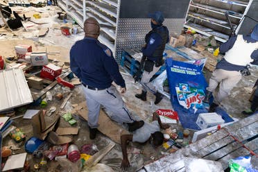 South African Police Services (SAPS) members arrest a looter at the Gold Spot Shopping Centre in Vosloorus, southeast of Johannesburg, on July 12, 2021. (File photo: AFP)