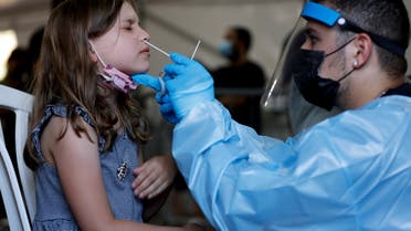 A healthcare worker tests a youth person for the coronavirus disease (COVID-19) at a temporary COVID-19 testing centre, at Rabin Square in Tel Aviv, Israel July 8, 2021. (Reuters)